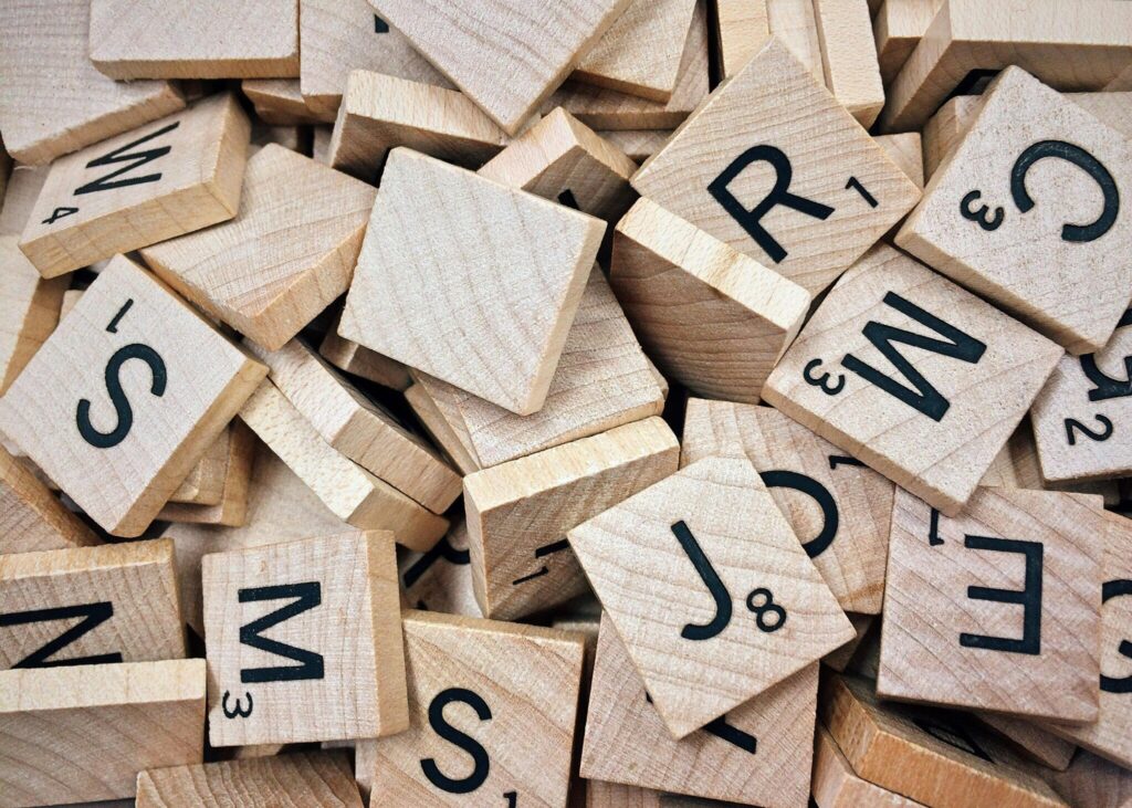 Is Your Business Ignoring the Hispanic Market in Virginia? Why You Need a Bilingual Website A collection of wooden Scrabble tiles with letters and numbers stacked randomly.